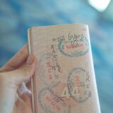 Close-up of a passport open to pages covered in travel and visa stamps